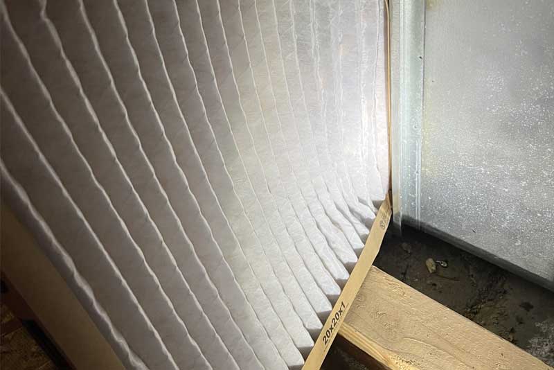 Pleated air filter in HVAC system installation.