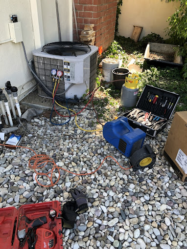 2025-07-15 Air conditioning repair tools and equipment outside unit.