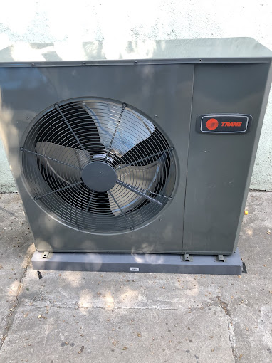 454554 Outdoor Trane air conditioning unit on concrete pad.