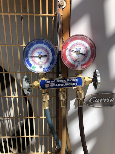HVAC manifold gauge on Carrier unit.