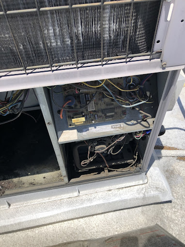 Open HVAC unit showing internal components and wiring.