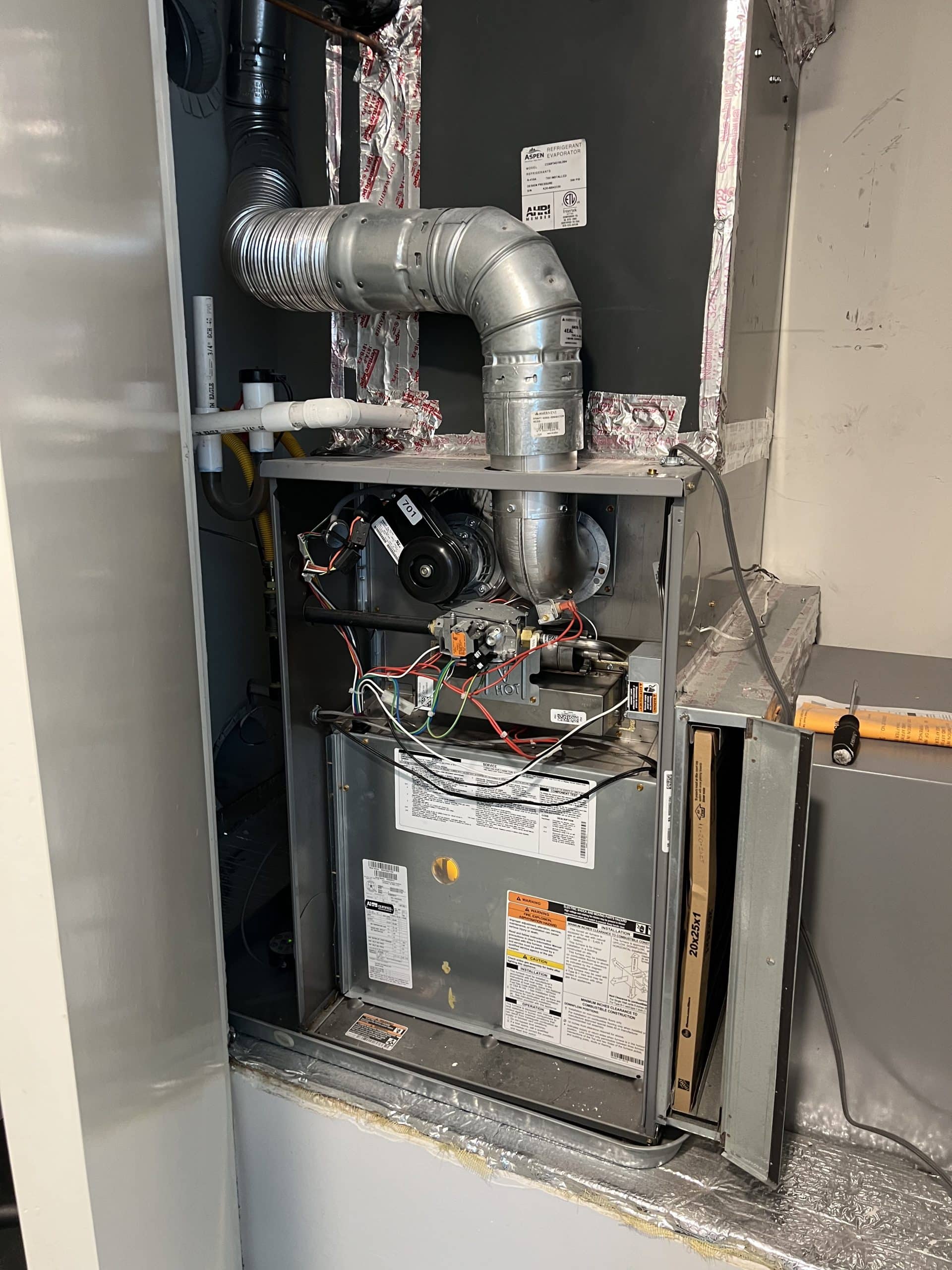 Open HVAC system with visible components and wiring.